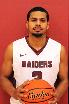 Pierce College basketball player wearing uniform and holding basketball