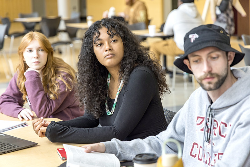 three students studying in cafeteria