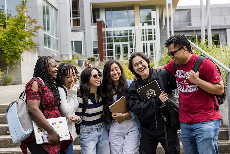 group of students smiling and laughing outside of cascade building