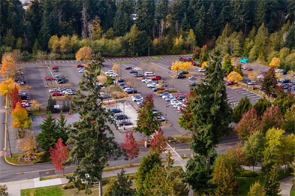 aerial view of cars in parking lot outside arts and allied health building on puyallup campus
