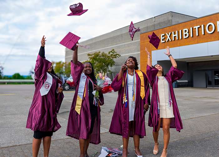 Pierce College alumnas celebrate the 2025 commencement ceremony outside the Tacoma Dome 