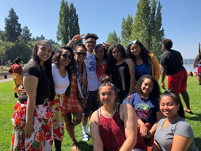 Group of ASPIRE students outdoors in a grassy park