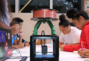 students drawing around 3d printer