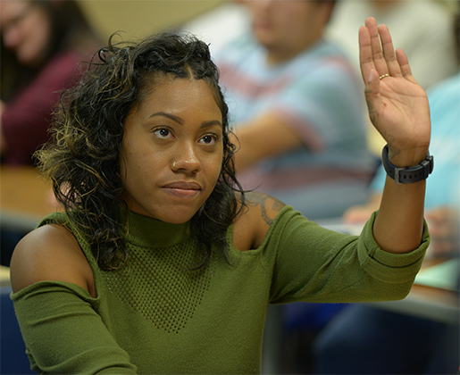 student raising hand in class