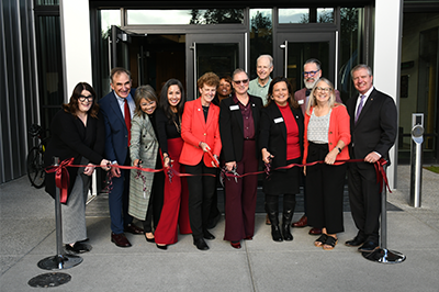 Pierce College Executive Team, Board Members, and retired Chancellor Michele L. Johnson cut a ribbon in front of the Johnson Science Building at Pierce College Puyallup