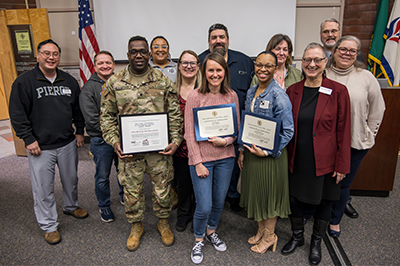 Pierce College at JBLM students, staff, and faculty pose at the 2024 Military Academic Achievement Awards Ceremony awards alongside Pierce Colege Chancellor and CEO Julie White.