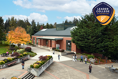 Pierce College Puyallup College Center Building behind the Achieving the Dream Leader College of Distinction logo -- a navy and gold badge with the organizations winged logo