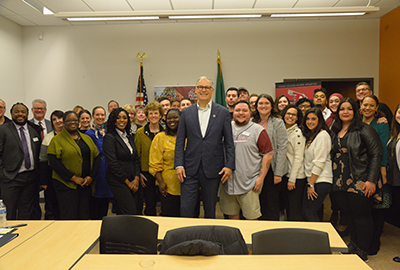 Governor Jay Inslee surrounded by Pierce College students, faculty and staff