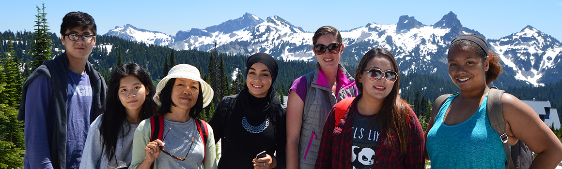 students with hiking gear outside with mount rainier in the background