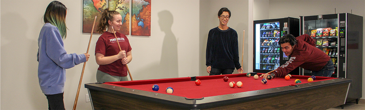 students playing pool in the residence hall