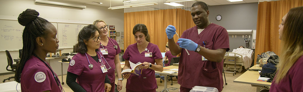 nursing students practicing treating a hospital patient