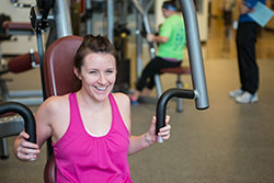 woman student working out on exercise machine