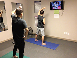 students exercising in residence hall fitness room
