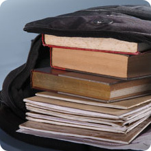 stack of books and notebooks in open backpack