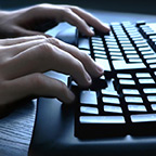 fingers typing on a computer keyboard